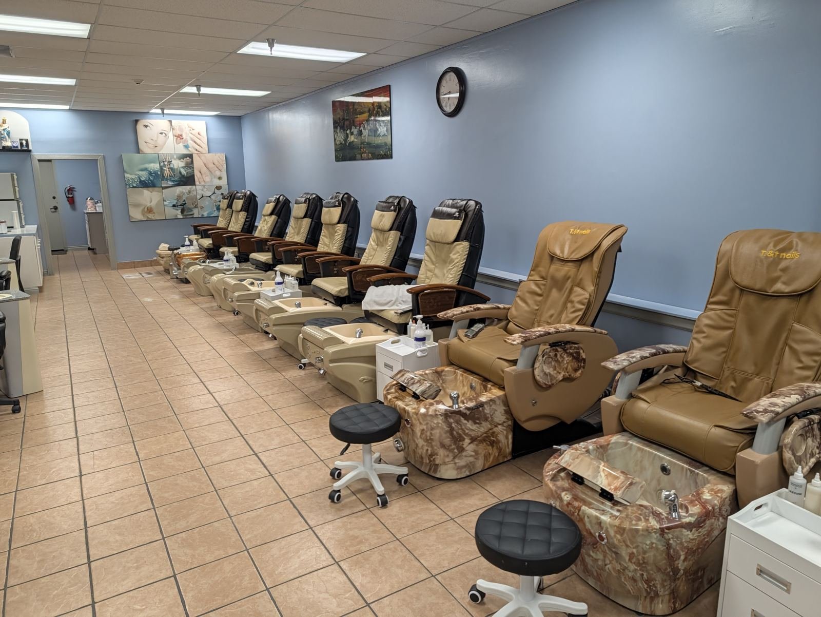 Pedicure chairs with the T & T Nails logo at our Bellingham nail salon